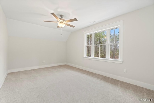 bonus room with baseboards and carpet