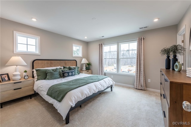 bedroom featuring baseboards, light carpet, recessed lighting, and visible vents