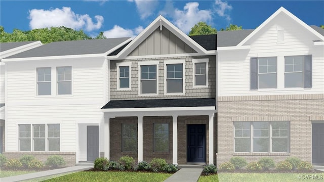 view of front facade with brick siding and board and batten siding