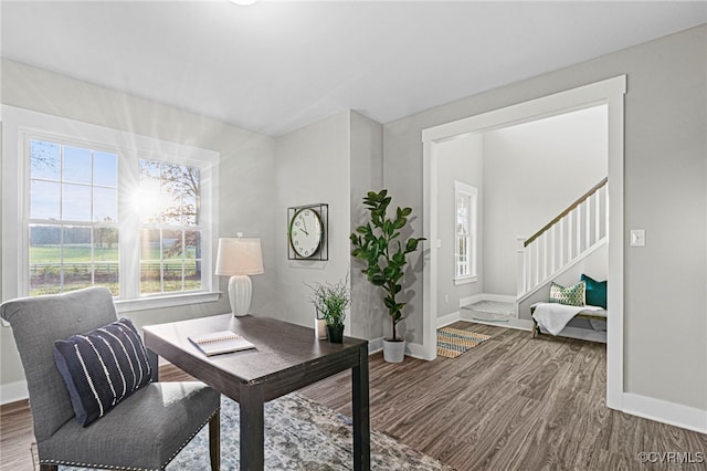 office area with plenty of natural light, baseboards, and wood finished floors