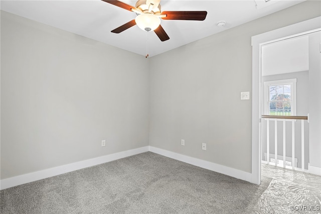 empty room with baseboards, a ceiling fan, and carpet