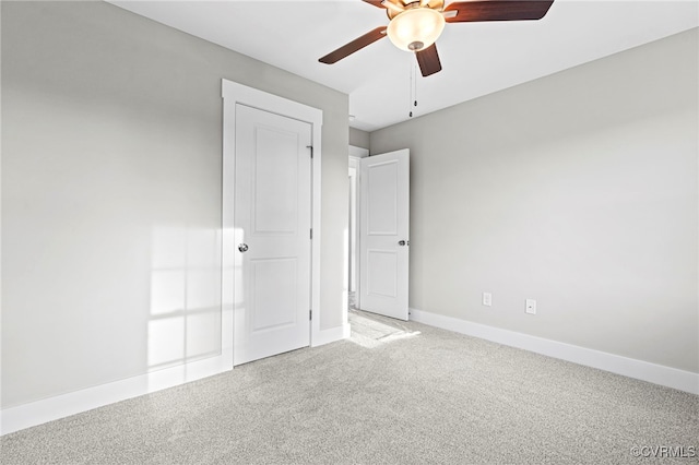 unfurnished bedroom featuring baseboards, a ceiling fan, and carpet floors