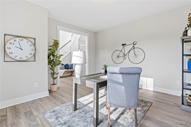 office area featuring baseboards and wood finished floors
