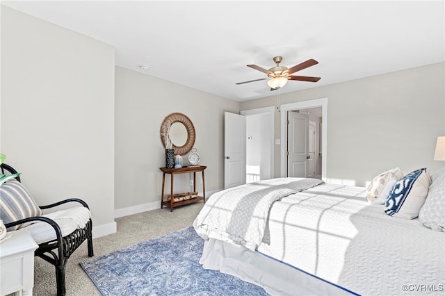 carpeted bedroom featuring baseboards and a ceiling fan