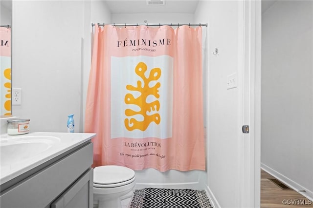 bathroom featuring vanity, toilet, curtained shower, and visible vents