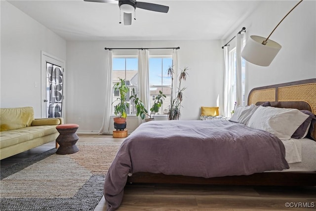 bedroom with a ceiling fan and wood finished floors