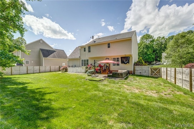back of property featuring a fenced backyard, a hot tub, and a lawn