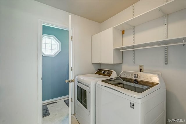 laundry room featuring washer and dryer, cabinet space, and visible vents