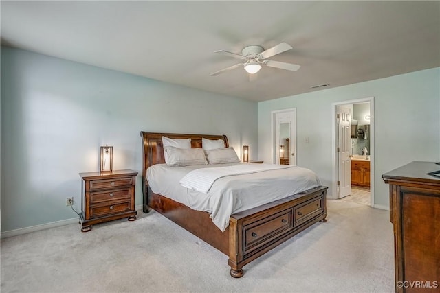 bedroom featuring ensuite bathroom, light carpet, baseboards, and visible vents