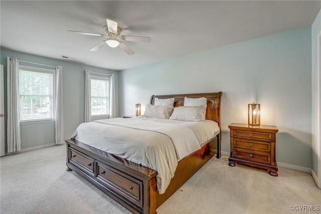 bedroom with light colored carpet, baseboards, a ceiling fan, and visible vents