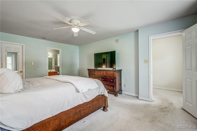 bedroom with ensuite bathroom, visible vents, light carpet, a ceiling fan, and baseboards