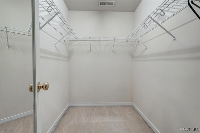 walk in closet with light carpet and visible vents
