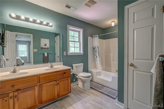 ensuite bathroom featuring a wealth of natural light, visible vents, and a sink