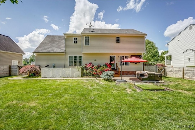 rear view of property featuring a fenced backyard, an outdoor hangout area, a patio, and a yard