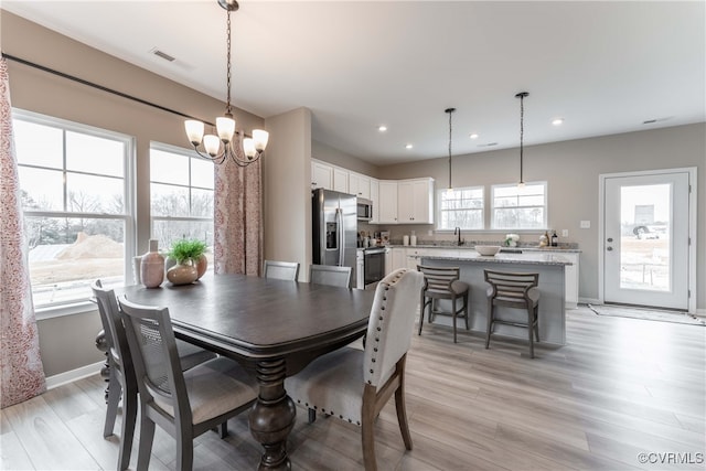 dining space featuring visible vents, baseboards, recessed lighting, a chandelier, and light wood finished floors