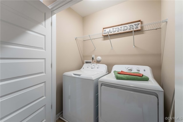 clothes washing area with laundry area and washer and clothes dryer