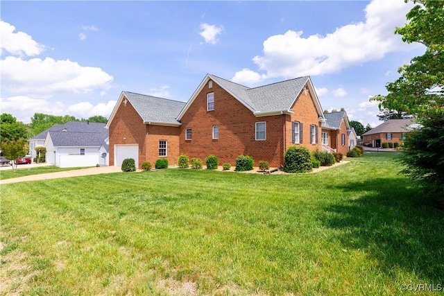 view of front of home with concrete driveway, brick siding, a front yard, and a garage