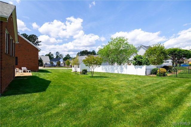 view of yard featuring fence and a residential view