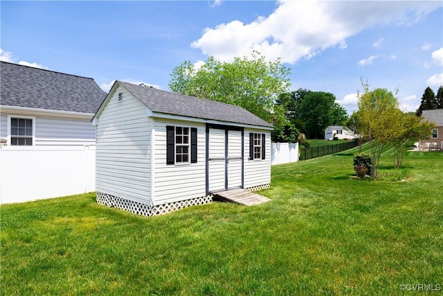 view of shed featuring fence