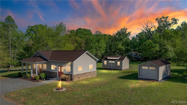 12421 Campbell Rd, Orange, VA 22960 - exterior space featuring a lawn, a detached garage, an outdoor structure, a storage unit, and a fire pit