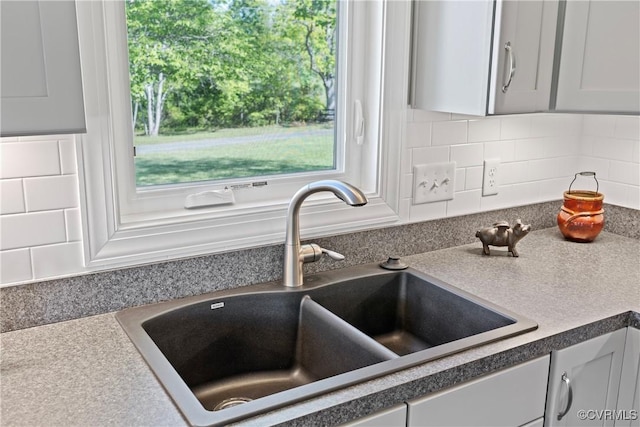 12421 Campbell Rd, Orange, VA 22960 - interior details featuring a sink, backsplash, and white cabinets