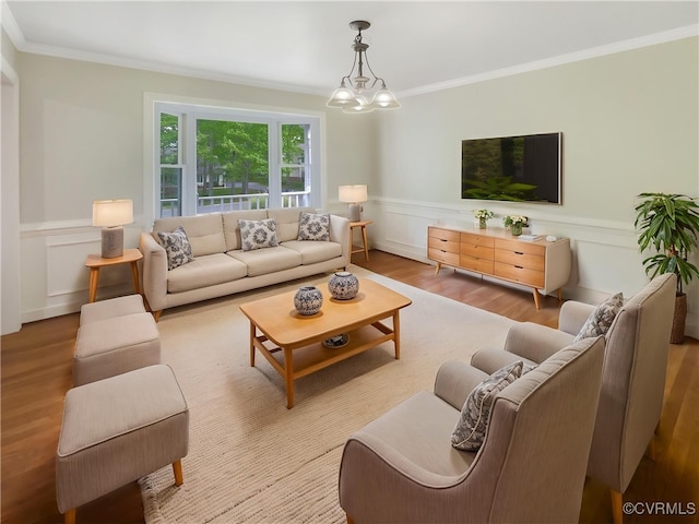 living area with crown molding, a decorative wall, wainscoting, and wood finished floors