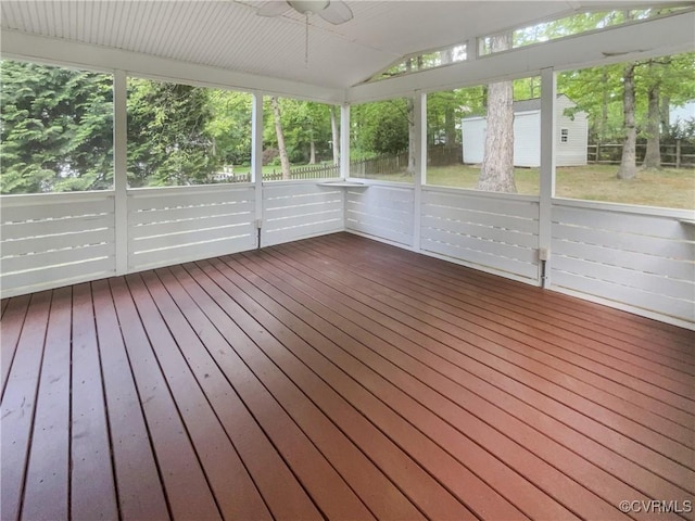 unfurnished sunroom with a ceiling fan and a wealth of natural light