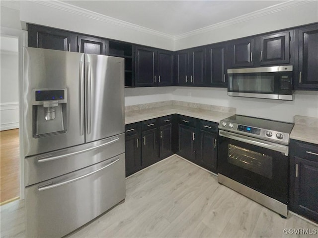 kitchen with dark cabinets, ornamental molding, and appliances with stainless steel finishes