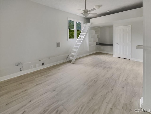 unfurnished room featuring baseboards, ceiling fan, and wood finished floors