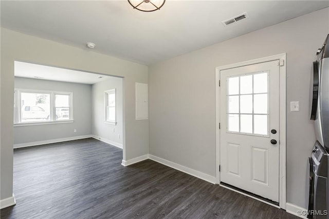 doorway to outside featuring baseboards, visible vents, and dark wood finished floors