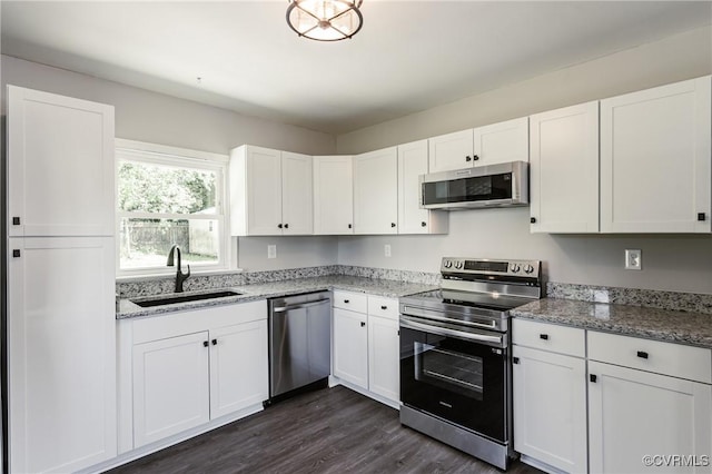 kitchen featuring a sink, stainless steel appliances, and white cabinetry