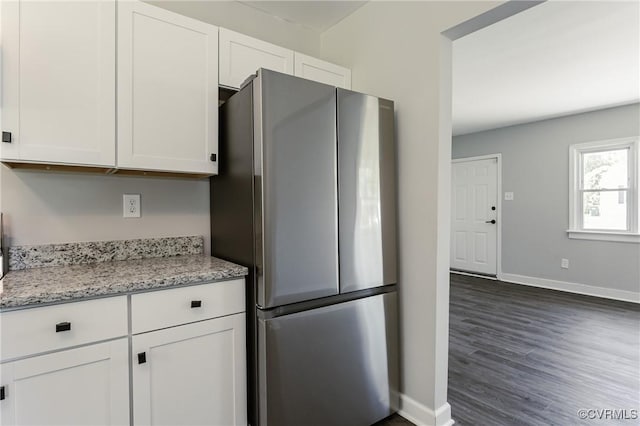 kitchen with baseboards, freestanding refrigerator, white cabinetry, and dark wood-type flooring