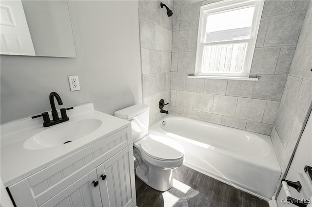 full bath featuring toilet, shower / washtub combination, wood finished floors, and vanity