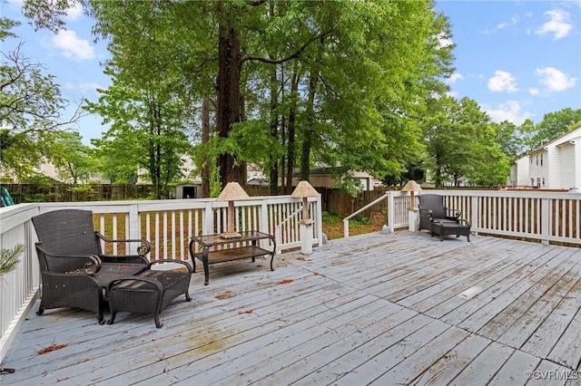 wooden terrace with a fenced backyard