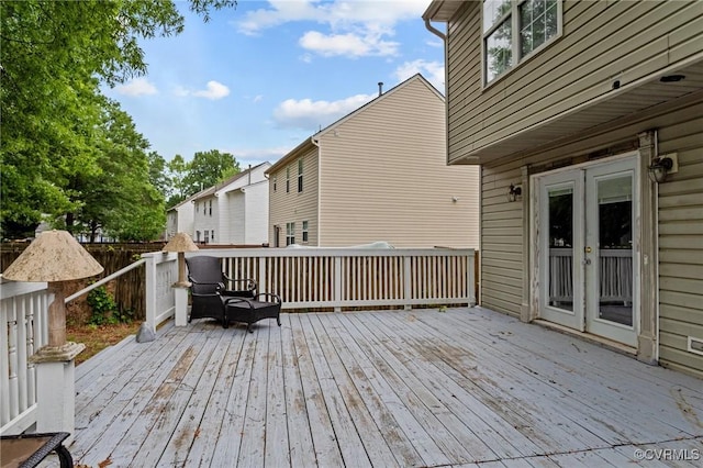 wooden terrace featuring french doors and fence