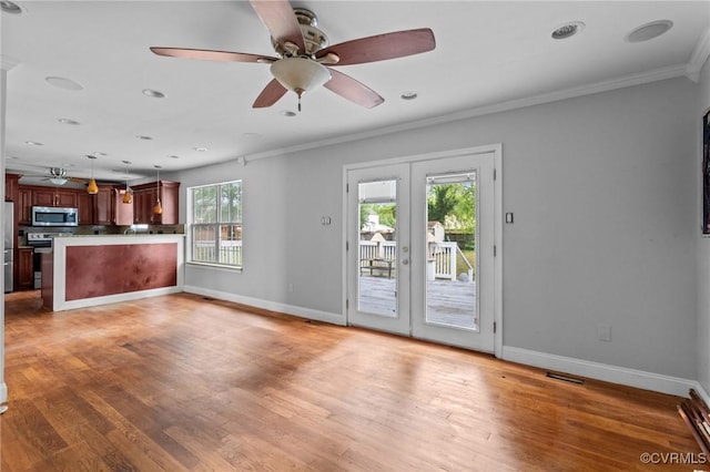 unfurnished living room with ceiling fan, french doors, ornamental molding, baseboards, and light wood finished floors