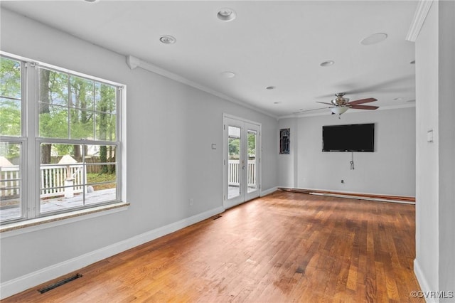 unfurnished living room featuring crown molding, wood-type flooring, baseboards, ceiling fan, and recessed lighting