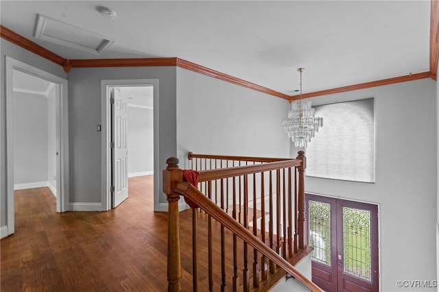 hall featuring an upstairs landing, wood finished floors, baseboards, crown molding, and french doors