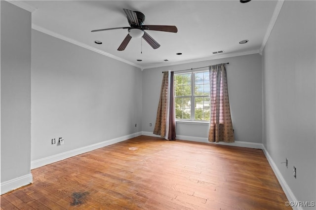 empty room featuring crown molding, wood finished floors, baseboards, a ceiling fan, and recessed lighting