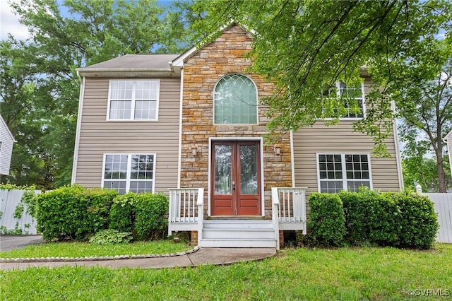 view of front of property featuring stone siding and french doors
