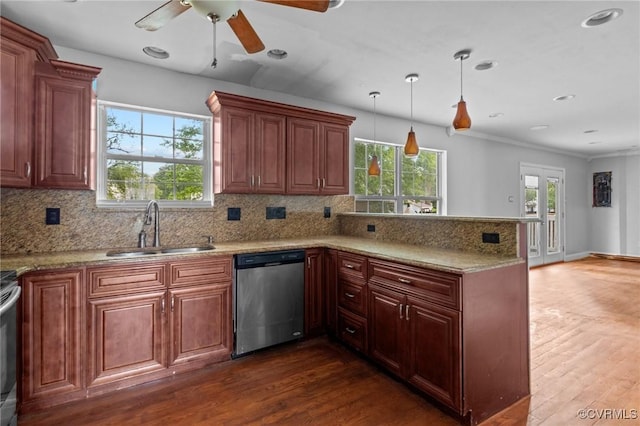 kitchen featuring dishwasher, a sink, a peninsula, dark wood finished floors, and ornamental molding