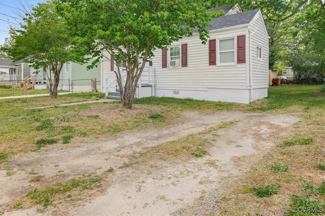 view of front of home with crawl space, fence, and roof with shingles