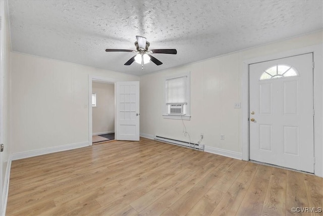 foyer entrance featuring baseboards, baseboard heating, light wood-type flooring, a textured ceiling, and a ceiling fan