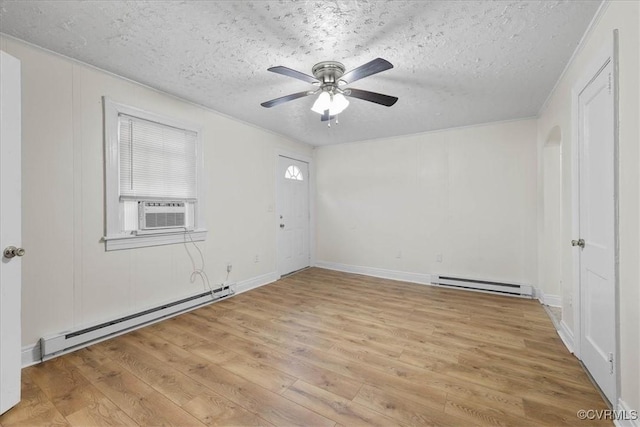 unfurnished room with light wood finished floors, ceiling fan, cooling unit, and baseboard heating