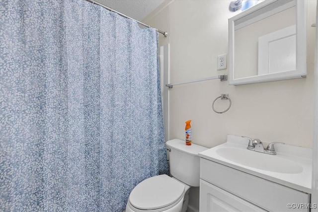 bathroom featuring toilet, curtained shower, and vanity