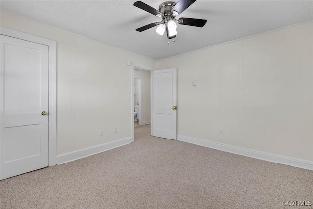 unfurnished bedroom with baseboards, a textured ceiling, carpet, and ceiling fan