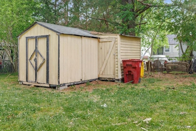 view of shed featuring fence