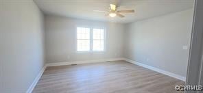 unfurnished room with a ceiling fan, baseboards, and wood finished floors