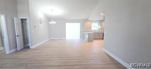 hallway with baseboards and light wood-style flooring