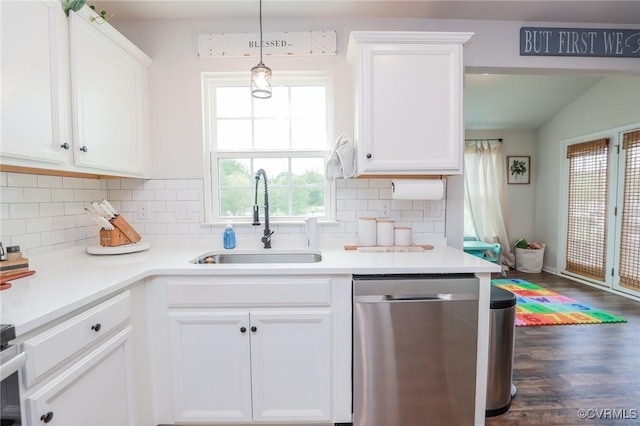 kitchen with stainless steel dishwasher, white cabinetry, a sink, and light countertops
